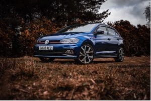 A blue car parked on grass