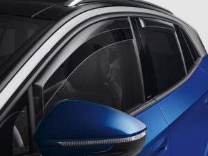 Close-up of a blue cars side featuring the rear-view mirror and partially open window. The car has a sleek, modern design with tinted windows and a silver roof rail. The image highlights the vehicles stylish exterior details.